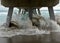 Beach scene with wooden fishing pier and waves in Atlantic Ocean in Florida