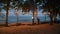 Beach with sea and lamp decoration on the tree in resort