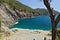 Beach in the sea near the Cinque Terre in Liguria. The rocks of the mountains plunge into the blue sea.