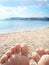 Beach and sea view through feet fingers