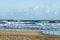 Beach shore with seagulls, big waves