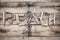 Beach sign made of driftwood on a wooden background