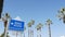 Beach sign and palms in sunny California, USA. Palm trees and seaside signpost. Oceanside pacific tourist resort aesthetic. Symbol