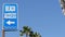 Beach sign and palms in sunny California, USA. Palm trees and seaside signpost. Oceanside pacific tourist resort aesthetic. Symbol