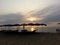 Beach with silhouette people, umbrellas and chairs