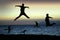 Beach silhouettes jump for joy