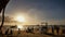 Beach with silhouettes of tourists among palm trees on the island of Boracay. Palm trees in the rays of sunset