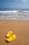 Beach slippers on sandy beach