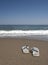 Beach slippers on a sandy beach