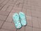 Beach Slippers turquoise stripe with flowers on the pavement