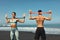 Beach. Sport Couple Workout With Resistance Band Outdoor. Handsome Man And Sexy Woman In Fashion Sporty Outfit.