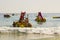 Beach staff and Holiday makers in hired Pedalos fight against the incoming surf to get out into calmer water at the beach in Albuf