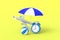 Beach striped umbrella, ball, airplane and alarm clock on yellow background