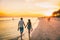 Beach summer beach people lifestyle happy couple enjoying sunset walk on Shelling beach famous tourist destination on