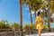 Beach summer lifestyle tourist woman walking on boardwalk in Florida, USA sun travel vacation leisure living