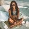 Beach summer portrait of beautiful tanned young woman