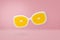 Beach sunglasses with orange lens on pink pastel, summer concept