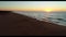 Beach Sunrise aerial view with waves lapping sand