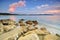 Beach at sunset with rocks