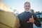 Beach, surf board and a happy elderly surfer man with hand sign and smile. Freedom, water sports and happiness, fun on