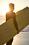 Beach, surfer and man with a surfboard at sunset thinking of of fitness training, workout or water sport exercise