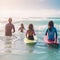 at the beach, surfers swiming in the sea and having fun in summer. Extreme sport and vacation concept. Father and