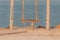 Beach swing at seaside coast in summer morning