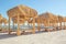 Beach with thatched gazebo and sun loungers