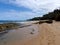 Beach with tide pool and foot prints