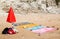 Beach towels and red umbrella in the sand near the sea