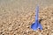 Beach toys - blue shovel on the beach