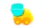 Beach toys: yellow plastic truck with blue trolley on white background