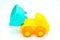 Beach toys: yellow plastic truck with raised trolley on white background