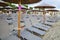 Beach with umbrella chairs in the row by the sea