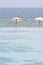 Beach umbrella on a deserted beach and sea; perfect vacation con