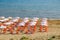 Beach umbrella and sunbeds on the sandy beach in Greece