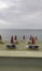 Beach with umbrellas, deck chairs and horizon.