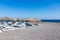 Beach umbrellas and deck chairs by the sea in Santorini