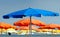 Beach umbrellas of different colors opened on the shore.