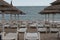 Beach umbrellas, empty sunbeds and lounge chairs at the beach in the romanian seaside in Neptun, Constanta Romania