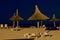 Beach umbrellas, lounge chairs, night