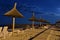 Beach umbrellas, lounge chairs, night