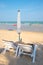 Beach umbrellas and sunbathe seats on beach in Thailand