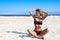 Beach vacation. Beautiful tanned woman in bikini relaxing on the tropical beach