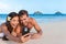 Beach vacation couple taking fun phone selfie on Hawaii vacation. Asian girl Caucasian man relaxing on Lanikai beach