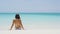 Beach vacation people - woman relaxing looking at perfect turquoise ocean water