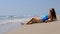 Beach vacation people - woman relaxing on the sandy beach.