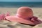 Beach vacation A pink straw hat rests on sandy shores