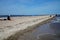 Beach with vacationers on the coast of the Baltic Bay in the village of Rewa, Poland