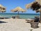 Beach in Vama Veche resort, with wooden sunbeds and reed umbrellas